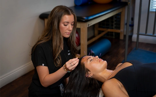 Chiropractor Phoenix AZ Emillie Castrichini with accupuncture patient